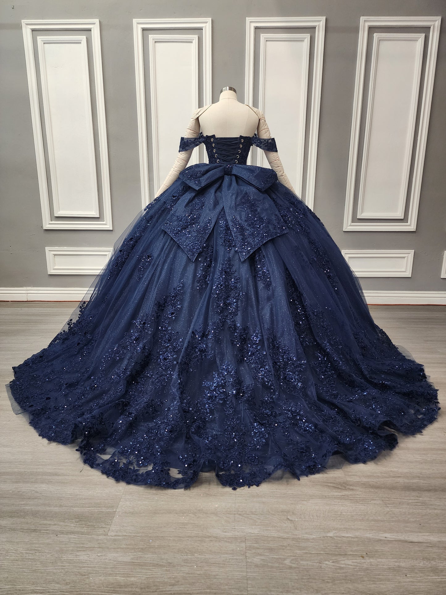 72592X – Navy Blue Off-Shoulder Quinceañera Dress with See-Through Corset, Full Ball Gown Skirt & Detachable Bow