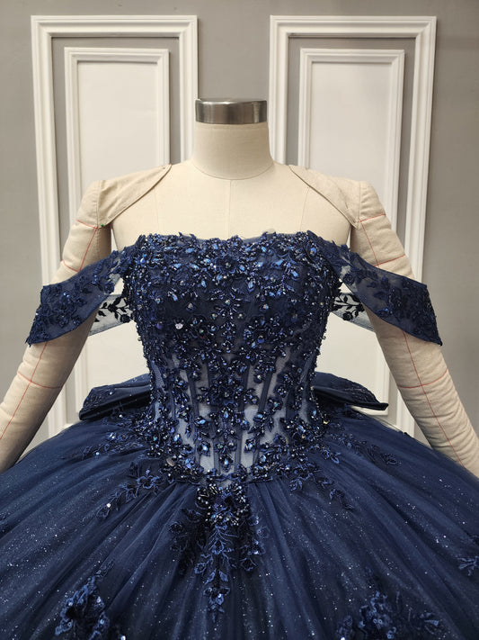 72592X – Navy Blue Off-Shoulder Quinceañera Dress with See-Through Corset, Full Ball Gown Skirt & Detachable Bow